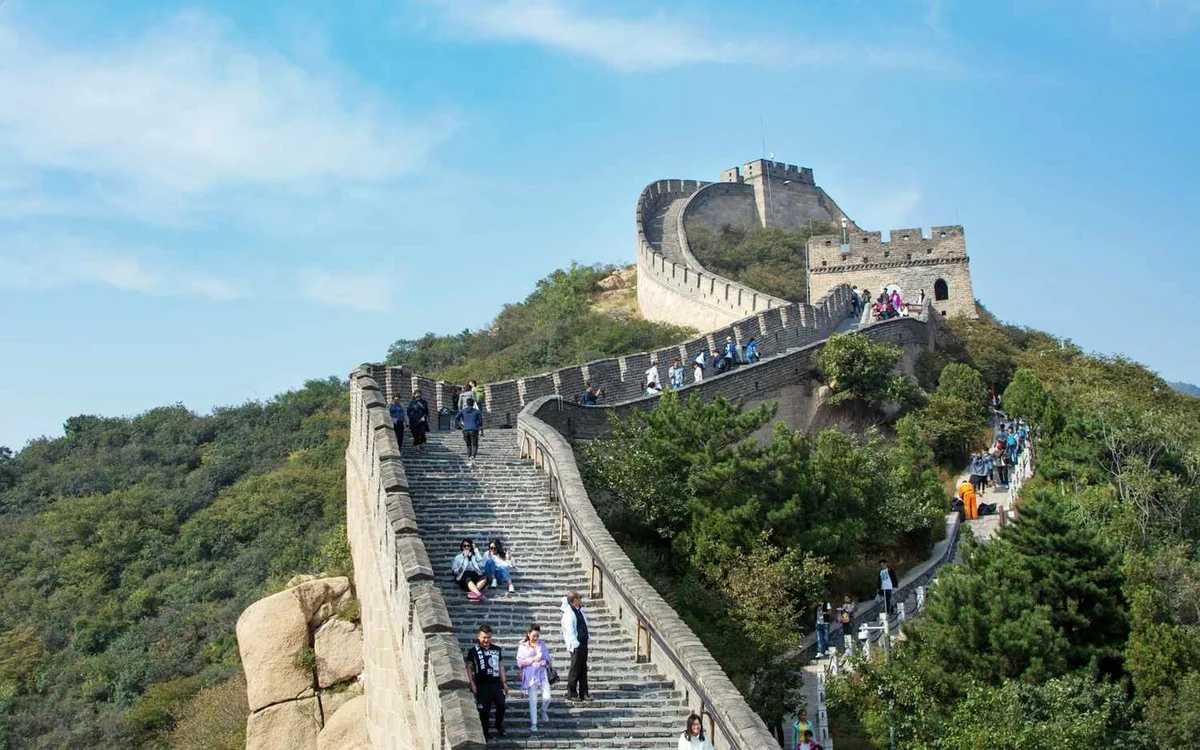 Travelers walking along the Great Wall of China on a clear day, showcasing one of China&amp;amp;amp;amp;amp;rsquo;s most iconic historical landmarks