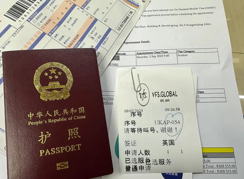 Passport, visa application documents, and appointment papers prepared before a China trip
