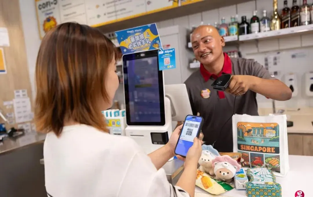 Traveler using mobile payment at a shop counter before confirming local spending options
