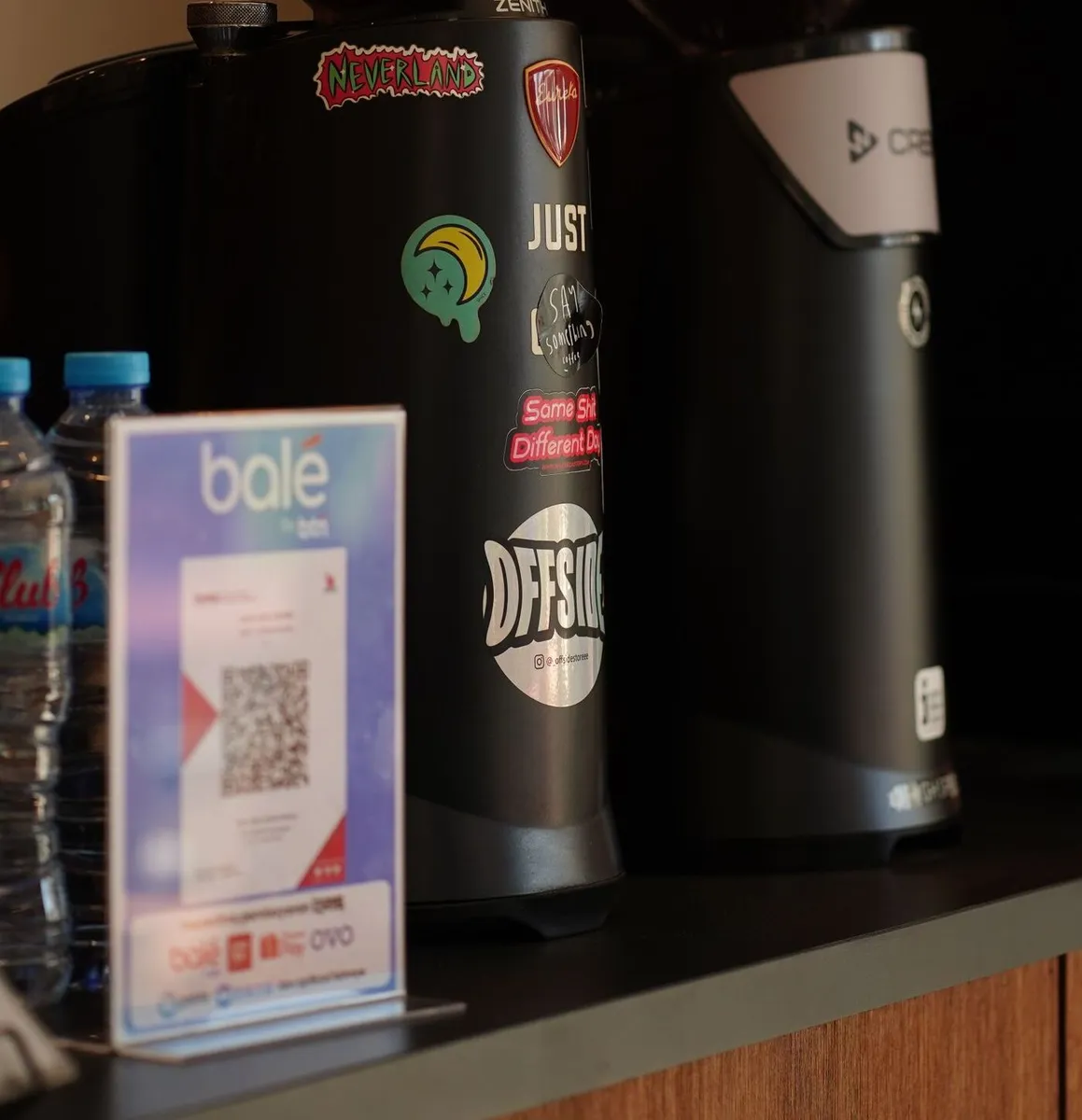 QR code payment stand at a cafe counter showing mobile payment use