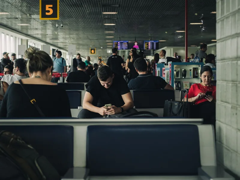 Travelers checking phone confirmations before a timed museum or attraction visit