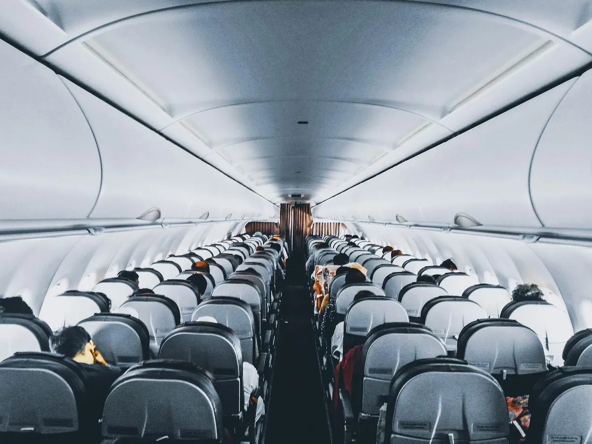 Aircraft cabin representing long-haul route planning before arriving in China