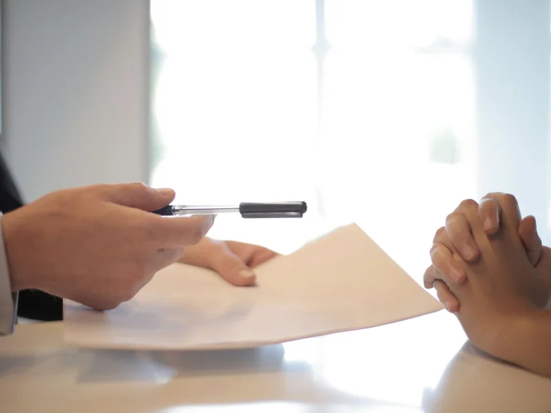 Traveler reviewing phone notes and documents for emergency preparation