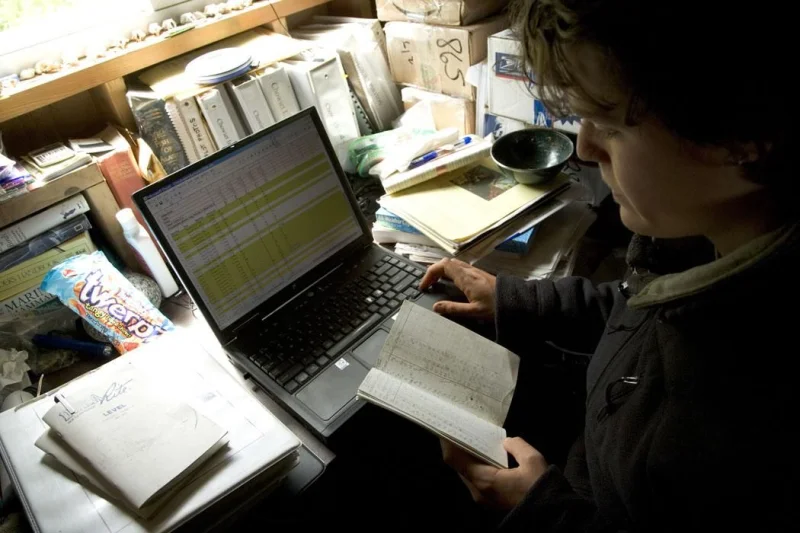 Traveler using a laptop to review written trip communication