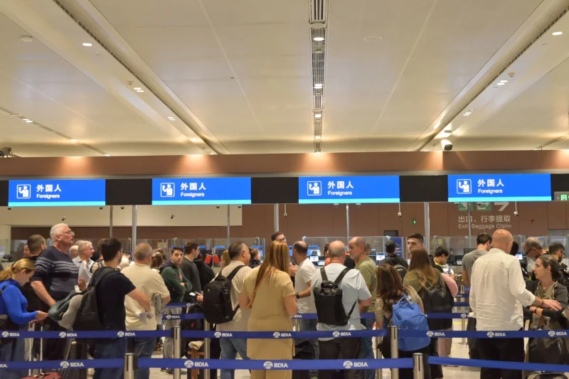 Airport check-in queue showing why domestic flight timing needs a full door-to-door comparison