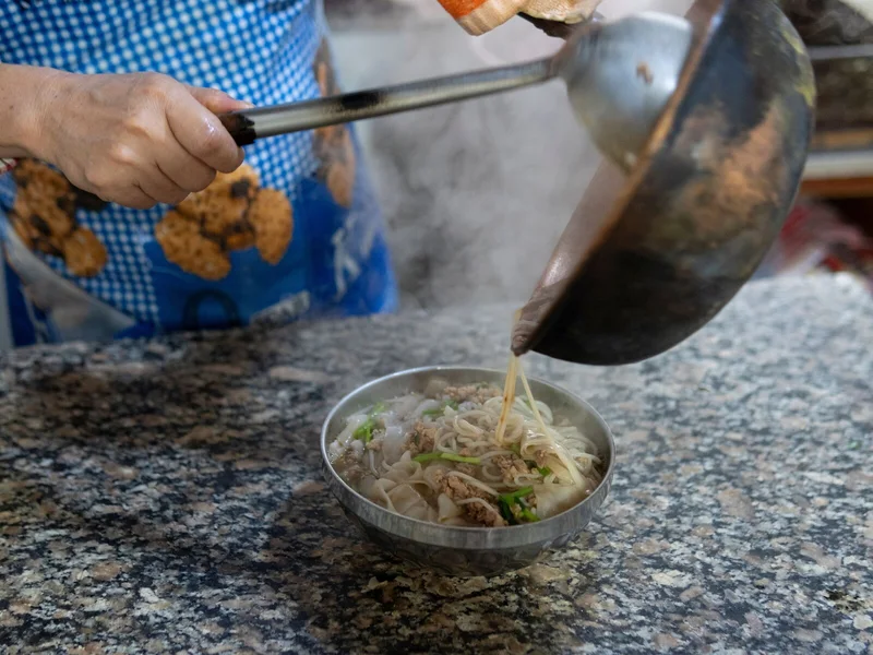Hot noodle soup being prepared in Yunnan during a practical China food stop