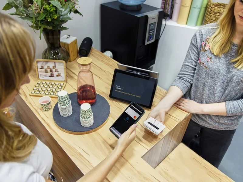 Mobile payment at a shop counter showing why travelers should prepare backup payment methods