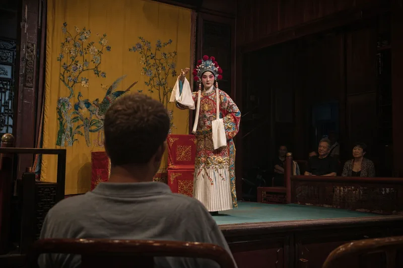 Traditional Chinese opera performer on stage viewed from the audience