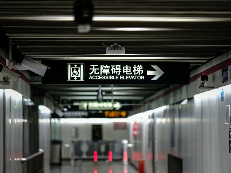 Elevator and accessible route sign showing why stairs and exits matter during China metro travel
